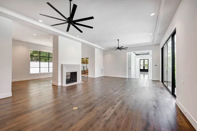 a large kitchen with cabinets and wooden floor
