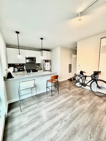 a bedroom with a bed and a night stand