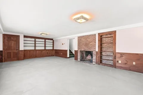 an empty room with furniture and a fireplace
