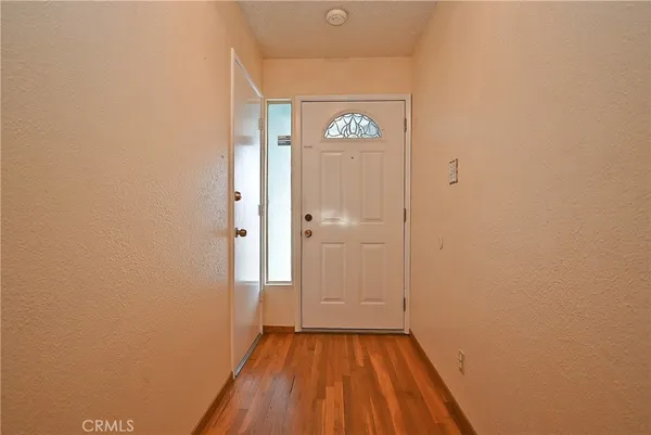 a view of a hallway with wooden floor
