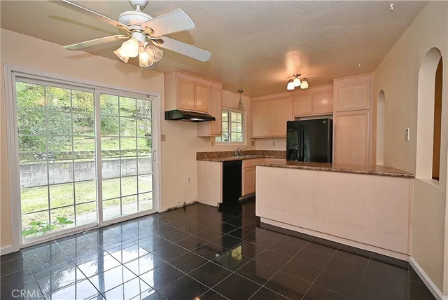 a view of a kitchen with a stove cabinets and a large window
