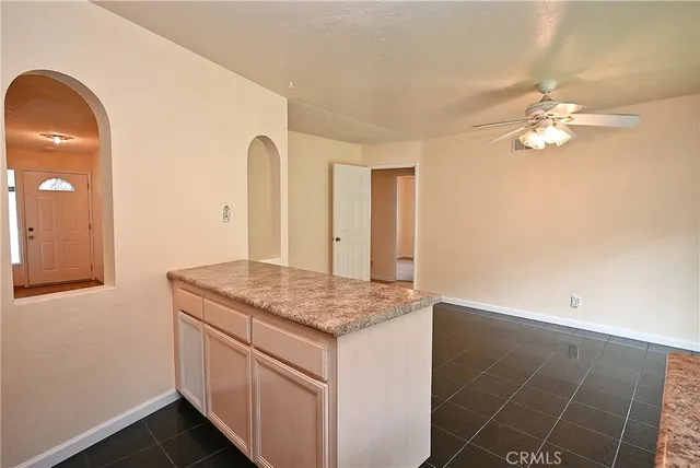 a kitchen with a sink cabinets and a window