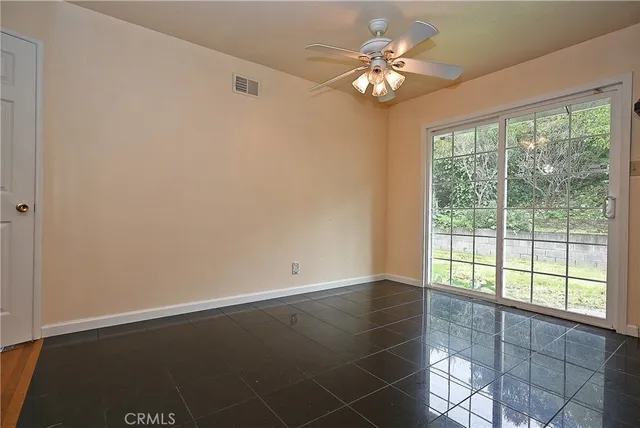 a view of room with window and ceiling fan