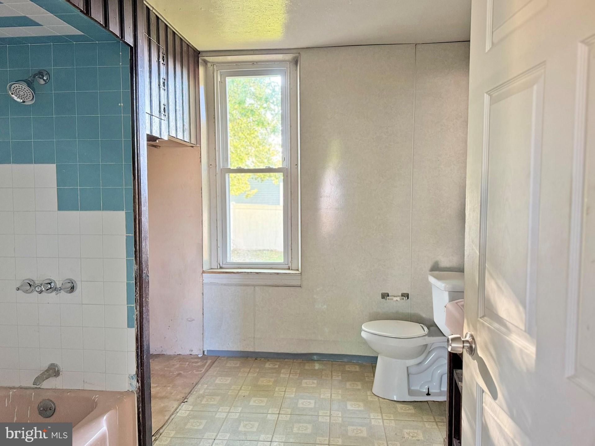 524 8th Avenue Lindenwold, NJ 08021 - Photo 10 of 19 a white toilet sitting next to a bathroom sink and tub