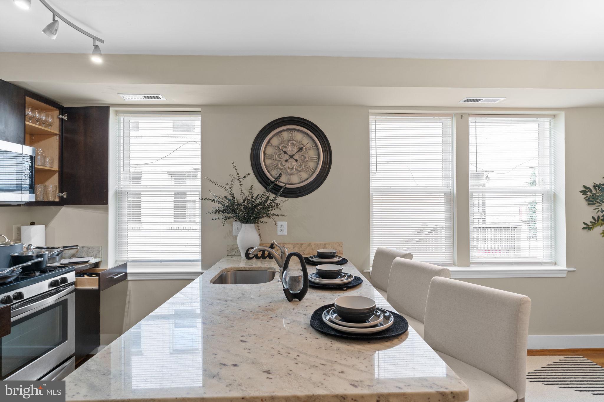 417 18th Street Northeast, Unit 103 Washington, DC 20002 - Photo 18 of 40 a kitchen with a stove a sink and a window