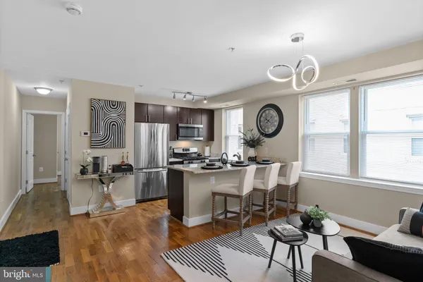 a large kitchen with a table and chairs