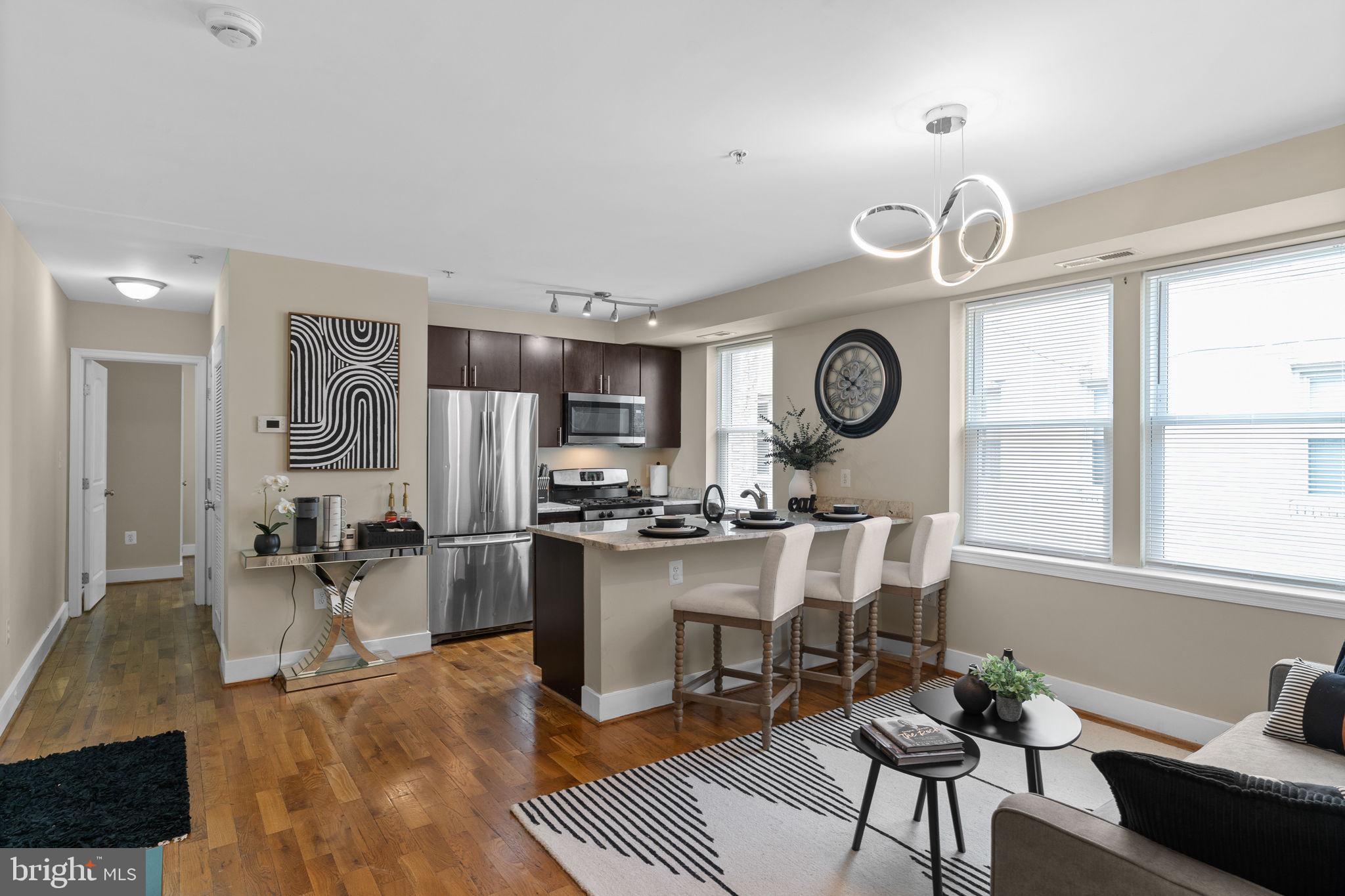 417 18th Street Northeast, Unit 103 Washington, DC 20002 - Photo 25 of 40 a large kitchen with a table and chairs