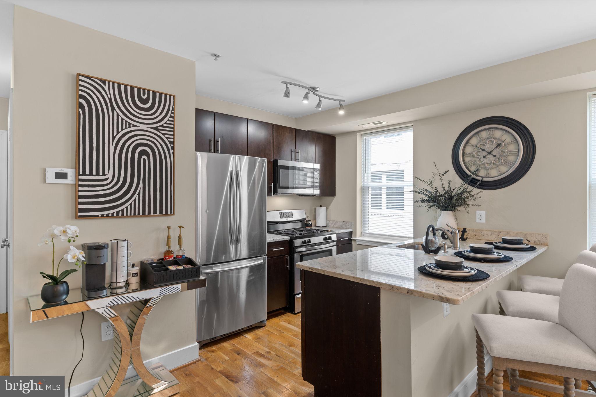 417 18th Street Northeast, Unit 103 Washington, DC 20002 - Photo 26 of 40 a kitchen with stainless steel appliances granite countertop a stove and a sink