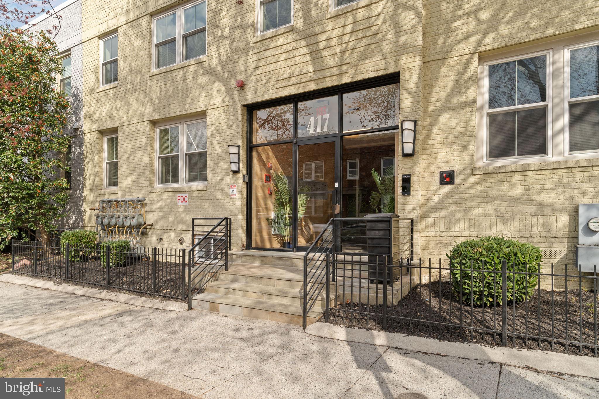 417 18th Street Northeast, Unit 103 Washington, DC 20002 - Photo 3 of 40 a view of a brick building with a bench in front of building