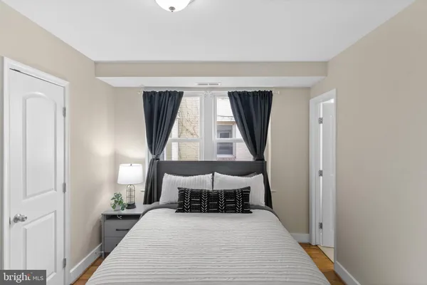 a bed room with a bed and a window