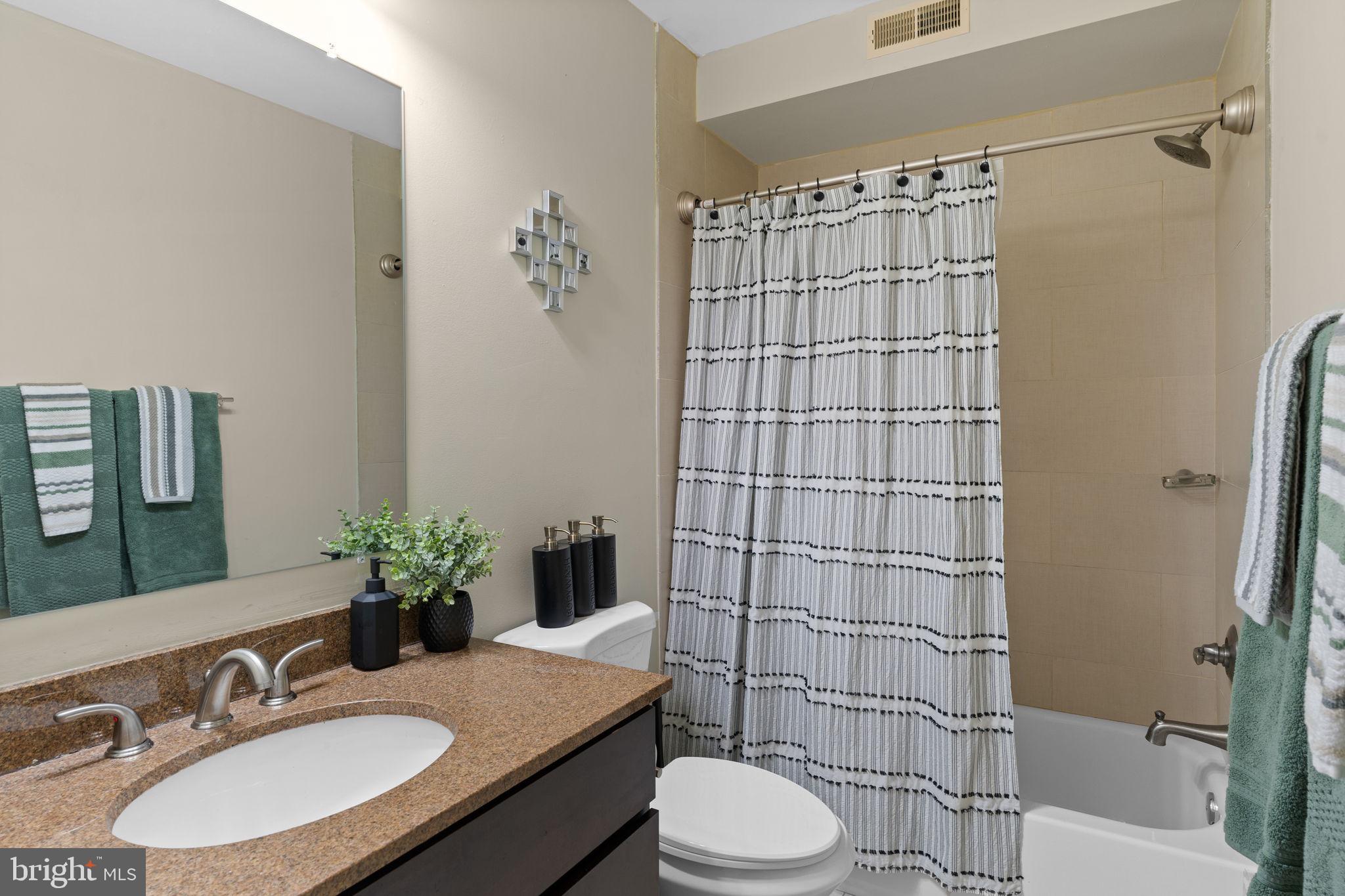 417 18th Street Northeast, Unit 103 Washington, DC 20002 - Photo 35 of 40 a bathroom with a sink toilet and shower