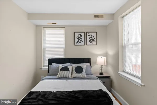 a bedroom with a bed and a window