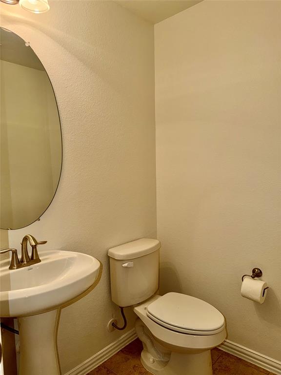 1308 Hudson Lane Prosper, TX 75078 - Photo 11 of 17 a white toilet sitting next to a bathroom sink