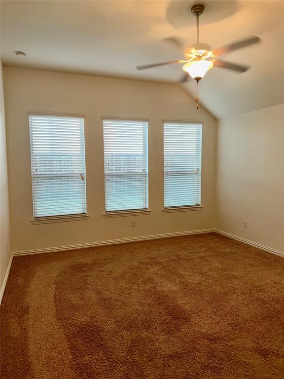 1308 Hudson Lane Prosper, TX 75078 - Photo 13 of 17 an empty room with a chandelier fan and windows