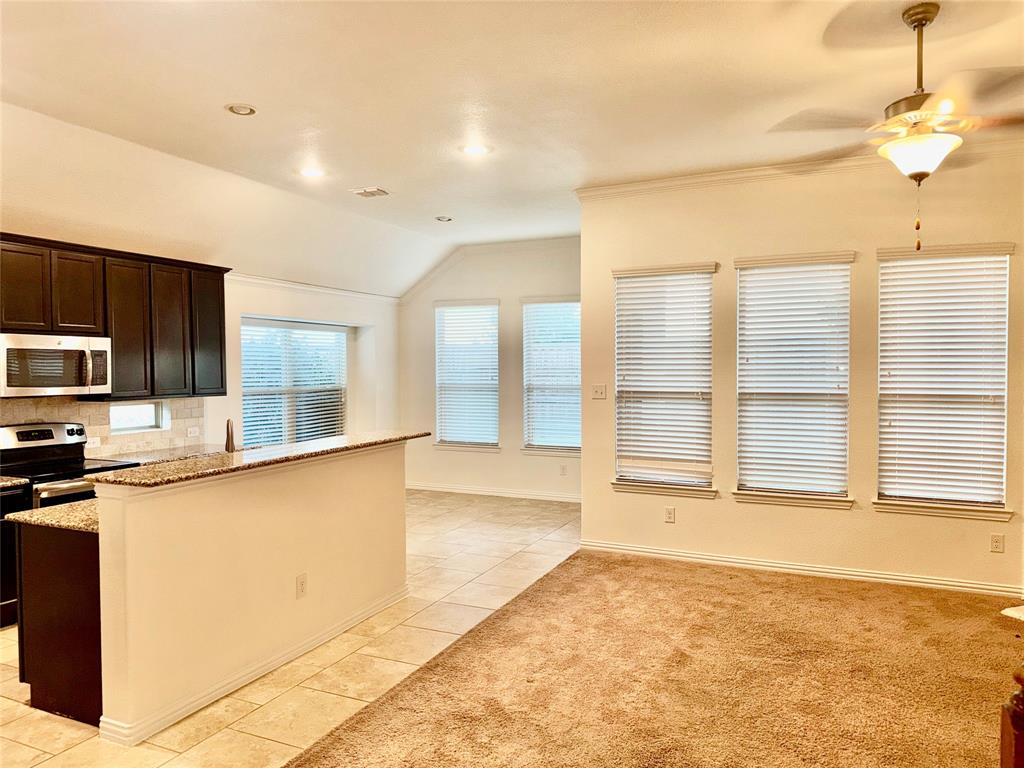 1308 Hudson Lane Prosper, TX 75078 - Photo 5 of 17 a large kitchen with stainless steel appliances granite countertop a sink and cabinets