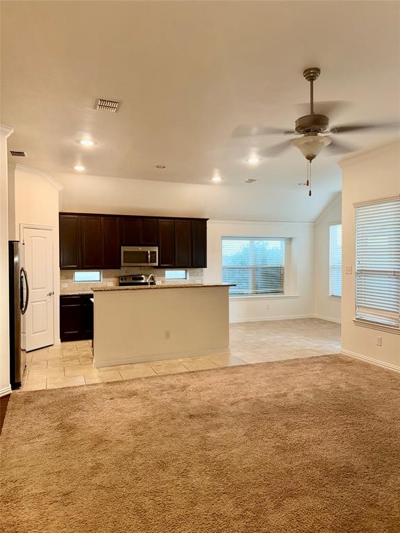 1308 Hudson Lane Prosper, TX 75078 - Photo 17 of 17 a large kitchen with stainless steel appliances kitchen island a large counter top and oven