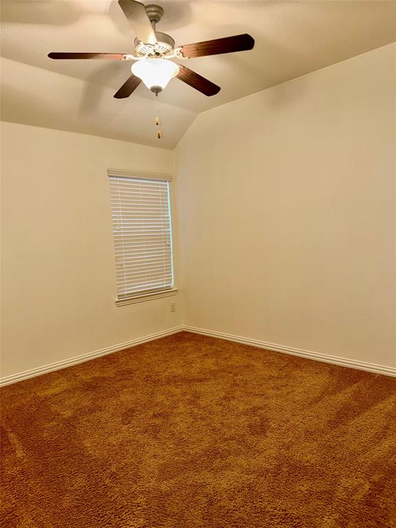 1308 Hudson Lane Prosper, TX 75078 - Photo 8 of 17 an empty room with a chandelier fan and windows
