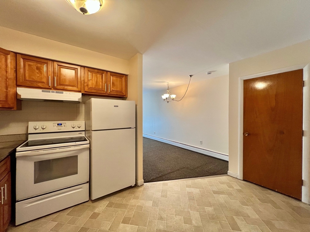 33 Paul Street, Unit 3314 Newton, MA 02459 - Photo 3 of 12 a view of a kitchen with washer and dryer