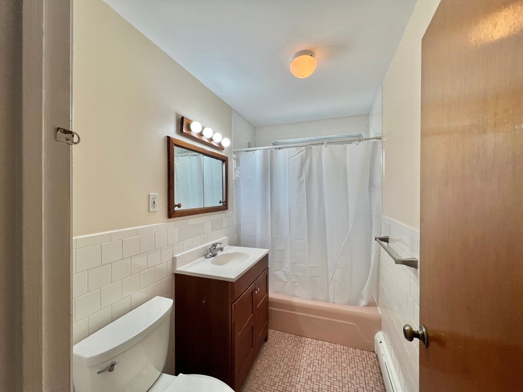 33 Paul Street, Unit 3314 Newton, MA 02459 - Photo 9 of 12 a bathroom with a sink a toilet and shower