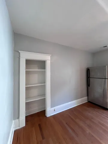 a view of an empty room with a closet
