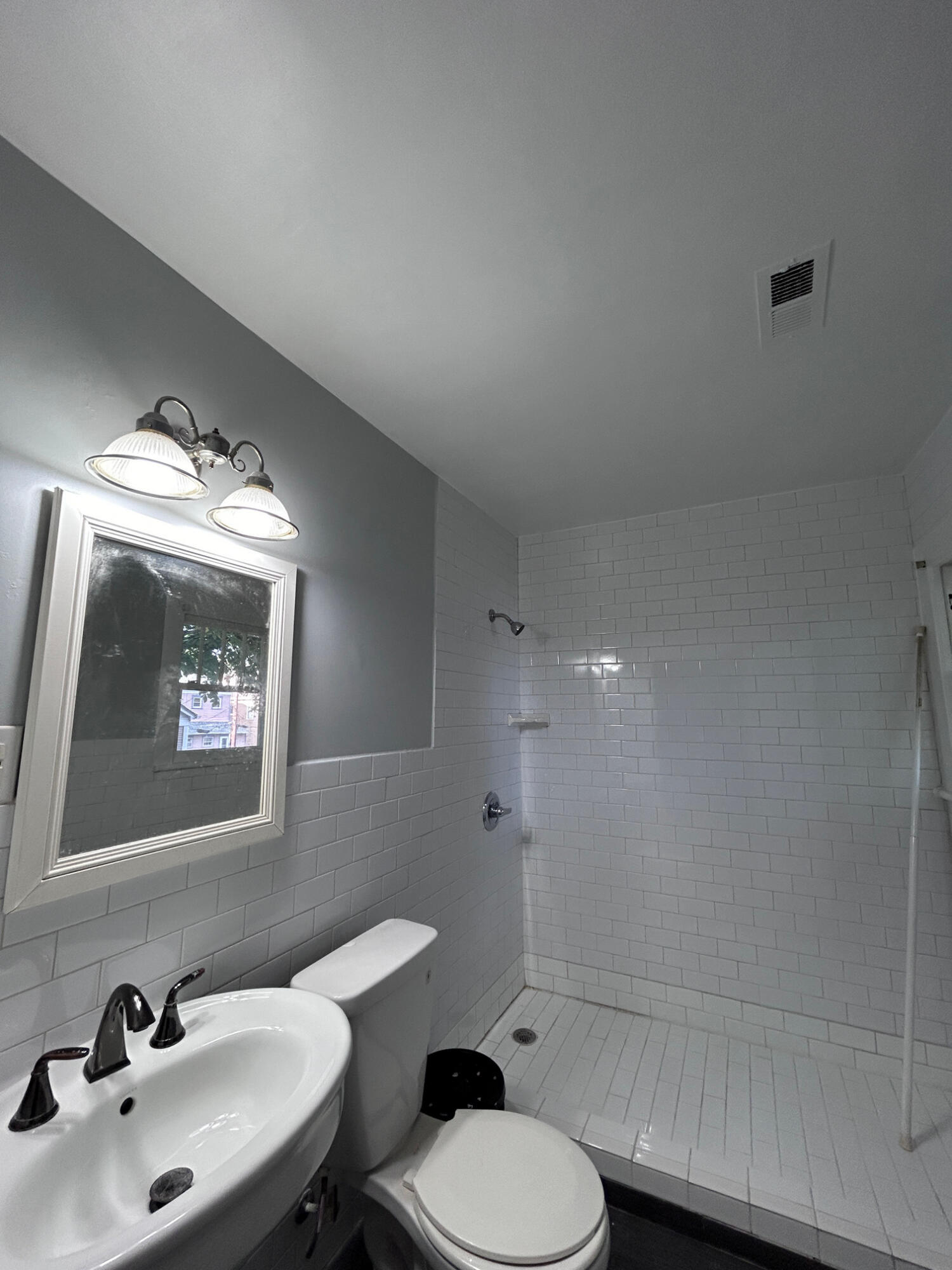 429 Albemarle Avenue Southwest, Unit UPPR Roanoke, VA 24016 - Photo 17 of 24 a bathroom with a toilet sink and mirror