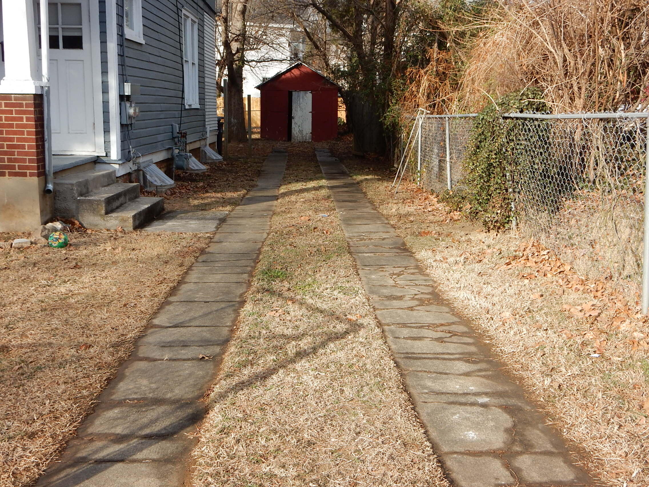429 Albemarle Avenue Southwest, Unit UPPR Roanoke, VA 24016 - Photo 23 of 24 a backyard of a house with large trees and outdoor seating