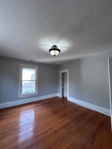 a view of a livingroom with a ceiling fan and window