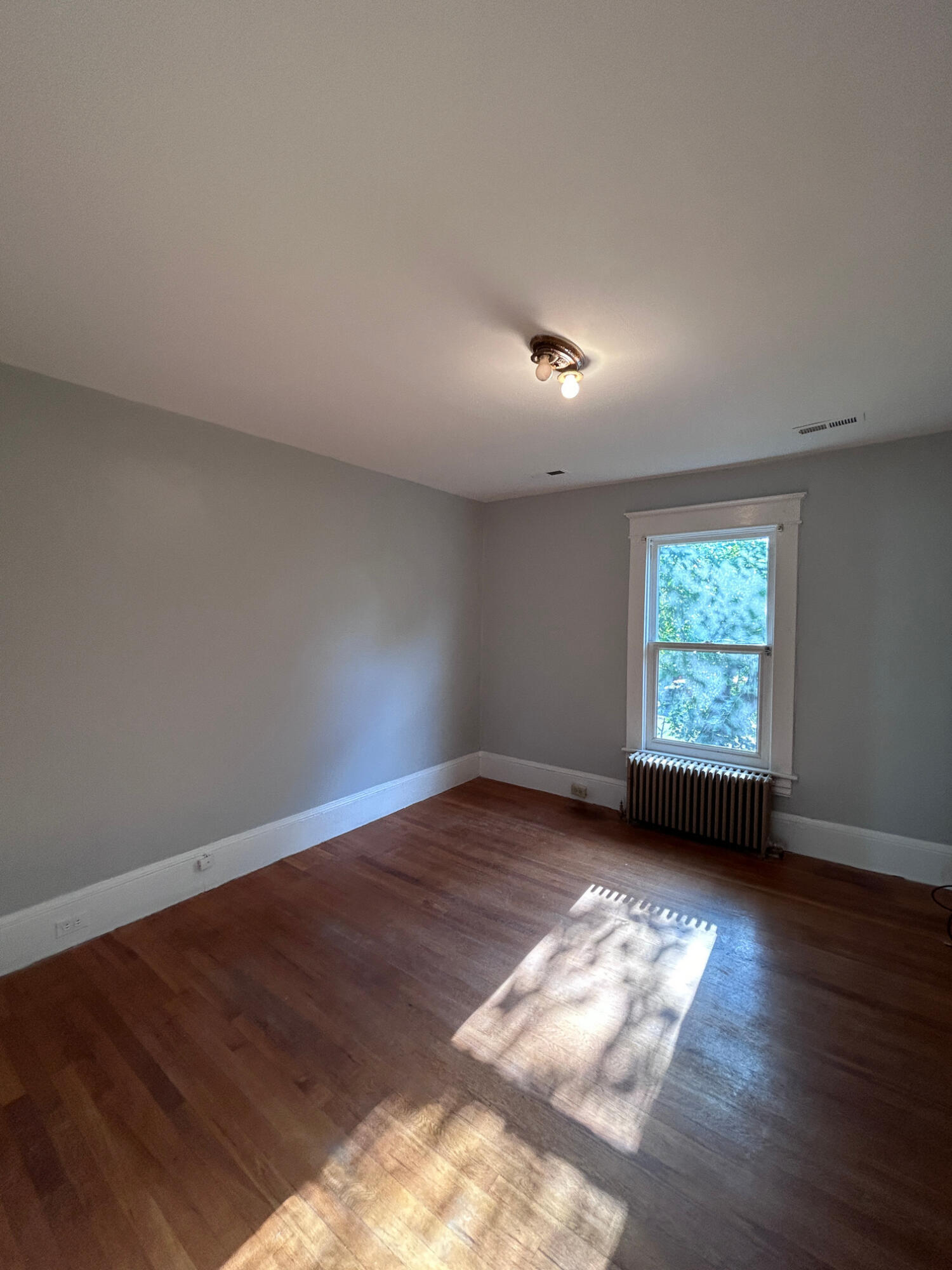 429 Albemarle Avenue Southwest, Unit UPPR Roanoke, VA 24016 - Photo 10 of 24 an empty room with wooden floor and windows