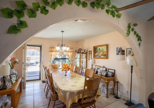 a view of a dining room with furniture and chandelier