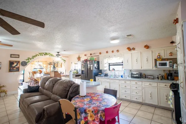 a very nice looking open kitchen with stainless steel appliances kitchen island granite countertop a sink and cabinets