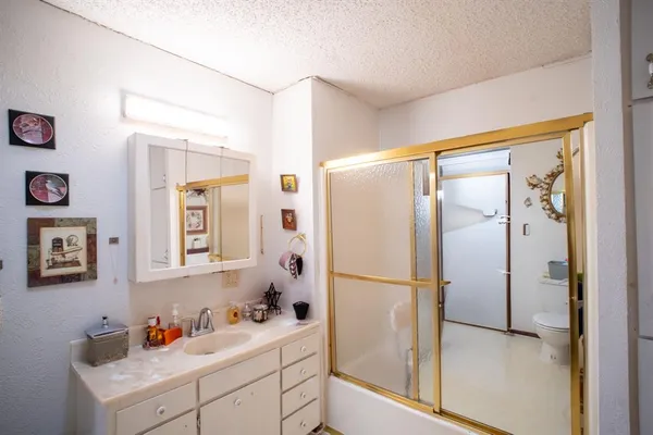 a bathroom with a sink mirror and a shower