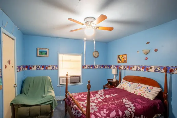 a bedroom with a bed and a chair