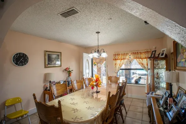 a view of a dining room with furniture and a chandelier