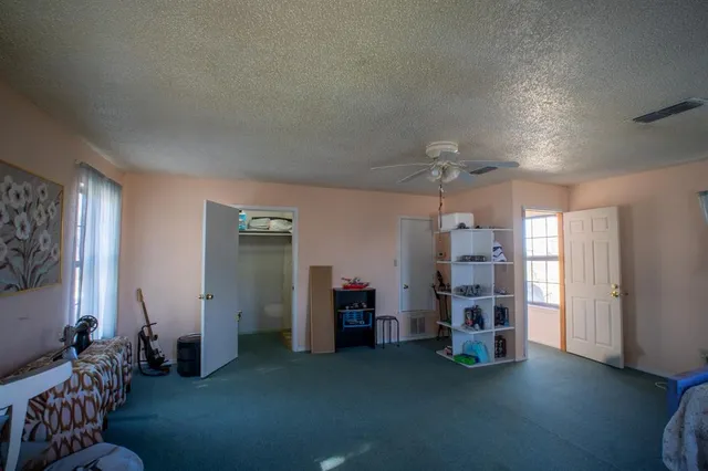 a view of a livingroom with furniture and bedroom