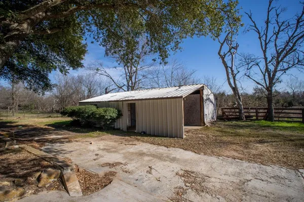 a view of a backyard with large trees