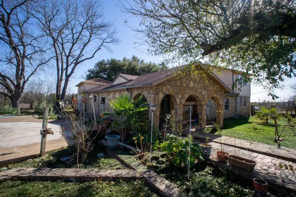 a front view of house with yard and green space