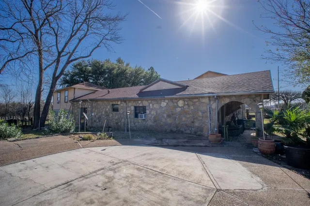 a backyard of a house with barbeque oven and outdoor seating