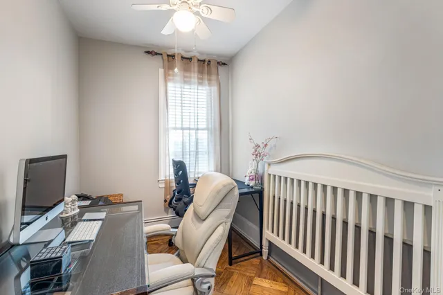 a view of a workspace with furniture and a window