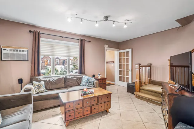 a living room with furniture and large windows
