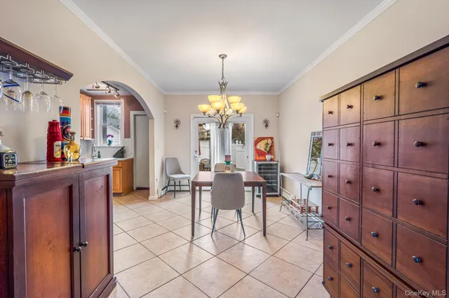 a view of a dining room with furniture and chandelier