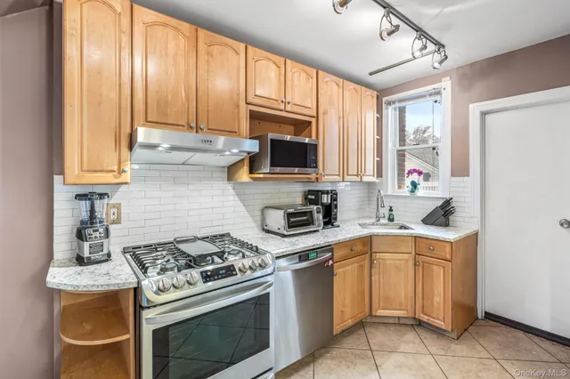 a kitchen with a stove a sink and a microwave