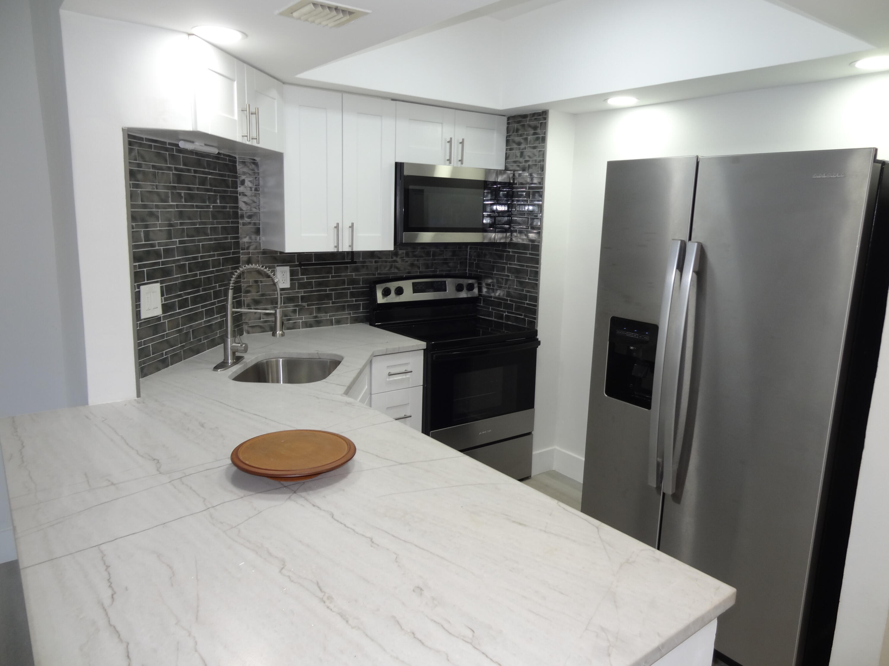 a kitchen with refrigerator and stove