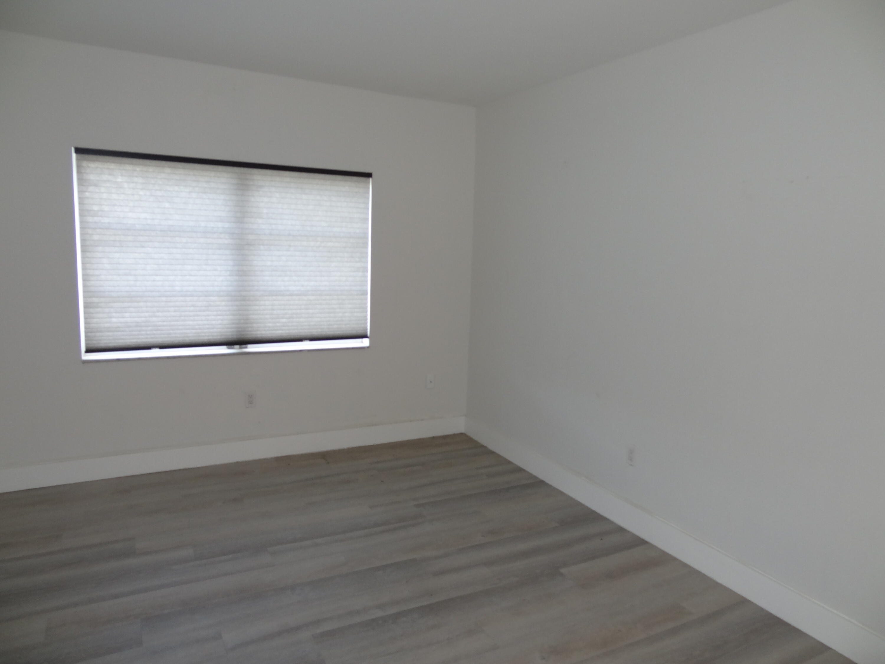 55 Southwest 2nd Avenue, Unit 2090 Boca Raton, FL 33432 - Photo 12 of 12 a view of an empty room with wooden floor and a window