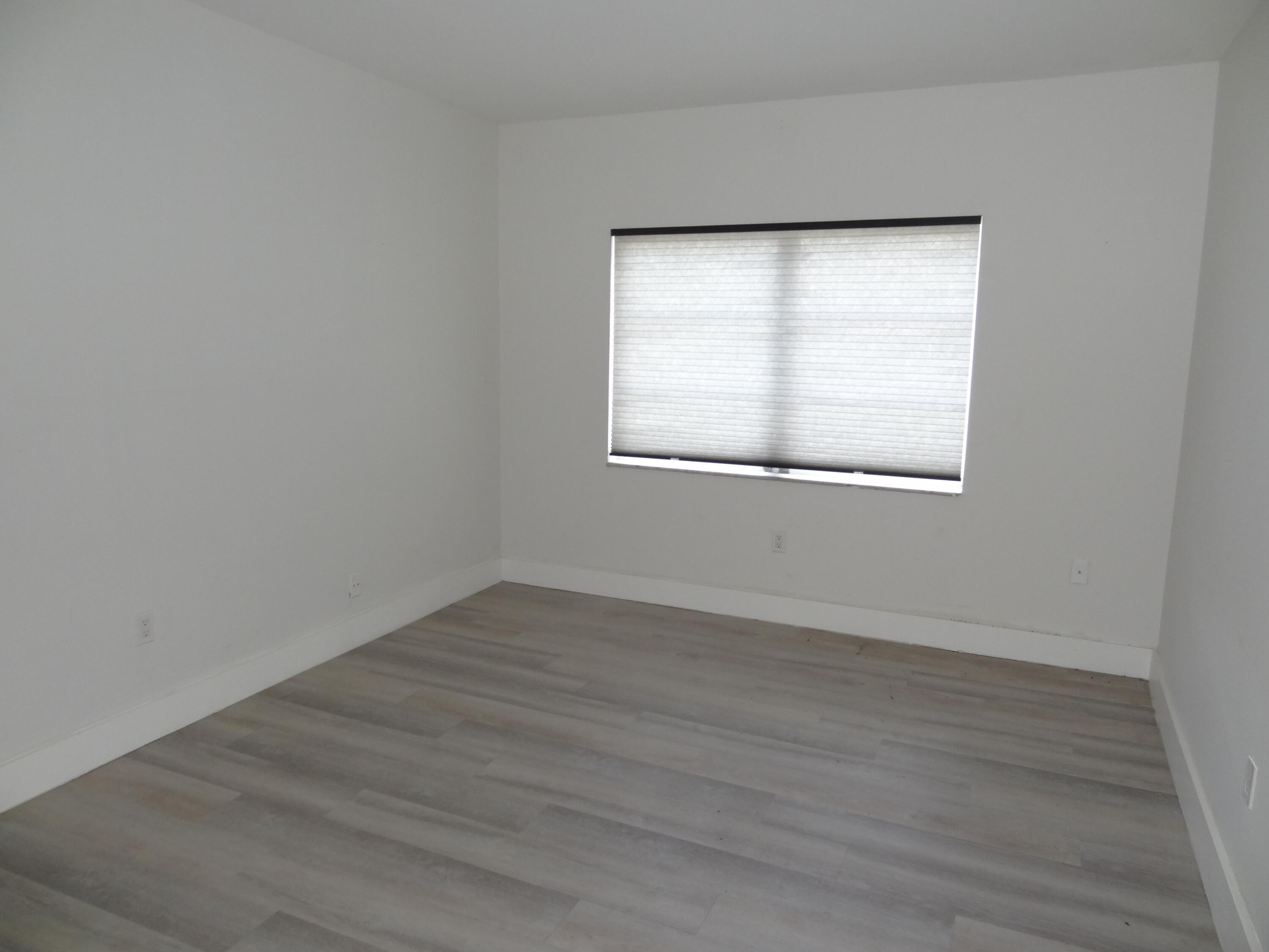 55 Southwest 2nd Avenue, Unit 2090 Boca Raton, FL 33432 - Photo 5 of 12 a view of an empty room with wooden floor and a window