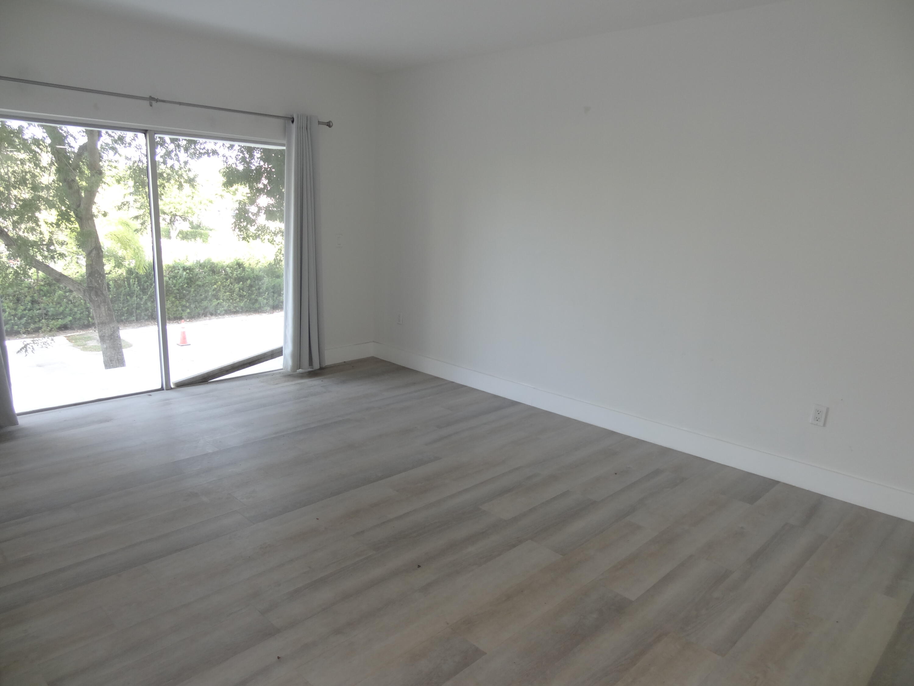 55 Southwest 2nd Avenue, Unit 2090 Boca Raton, FL 33432 - Photo 6 of 12 a view of an empty room with wooden floor and a window