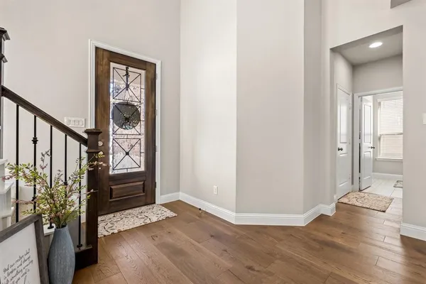 a view of entryway with wooden floor and stairs