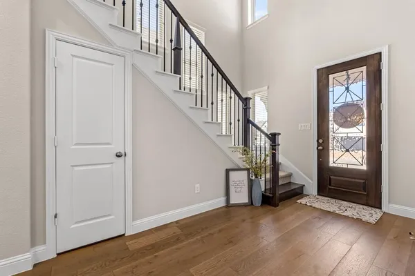 a view of an entryway with hardwood floor and windows