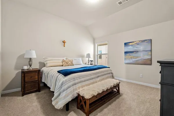 a spacious bedroom with a bed and window