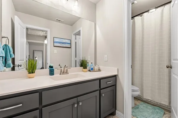 a bathroom with a double vanity sink and a mirror