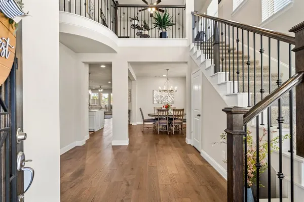a view of entryway and hall with wooden floor